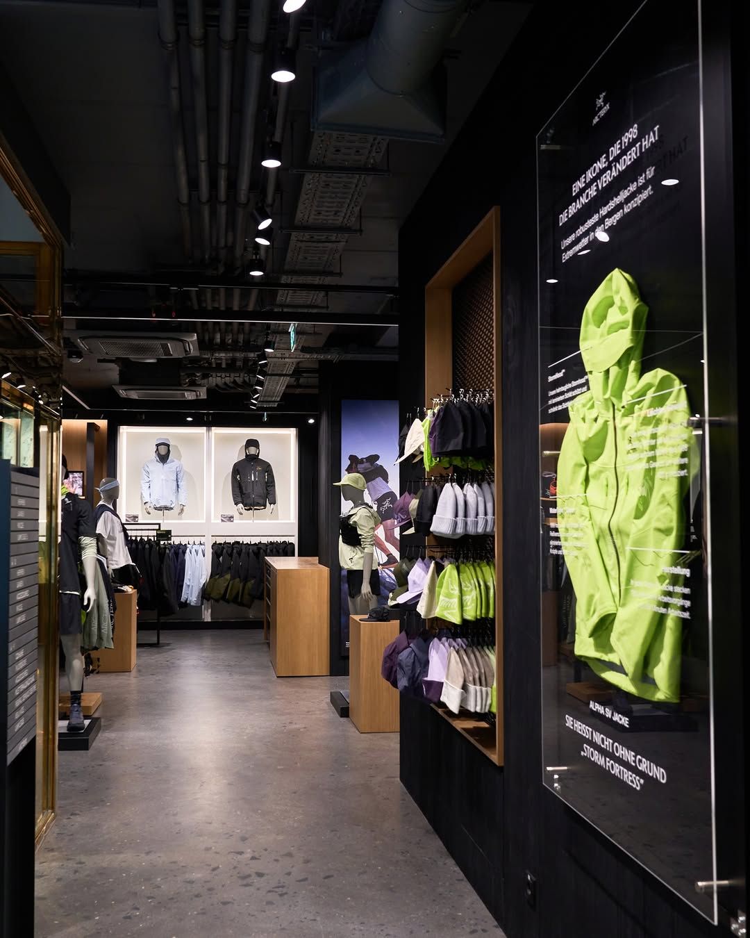 Completed Arc’teryx Vienna store interior, showing the customer route, timber fixtures and illuminated displays